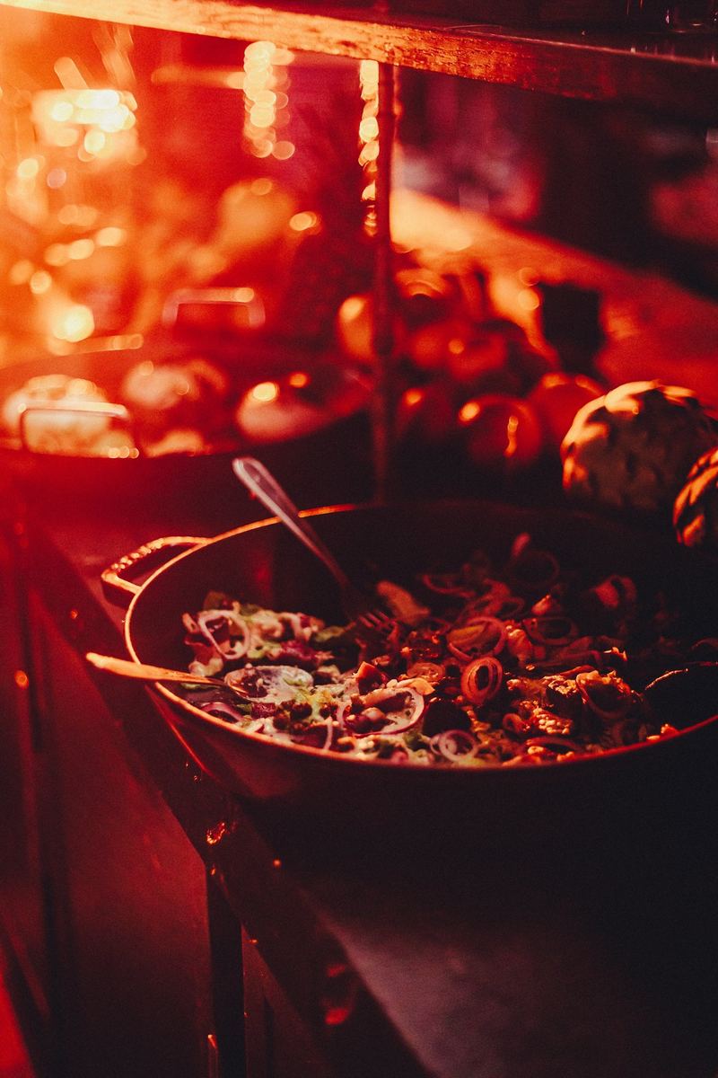 Grande poêle de fruits de mer en cuisson, sous la lampe chauffante