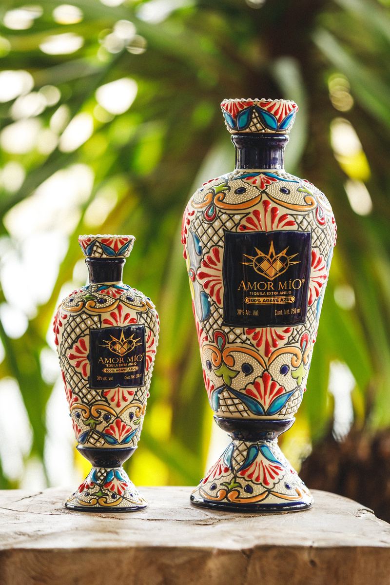 Deux flacons peints à la main présentés sur une souche, jardin tropical